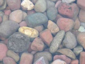 Glacial stones through the clear water of Lake McDonald