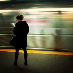 Woman Reading on Subway Platform